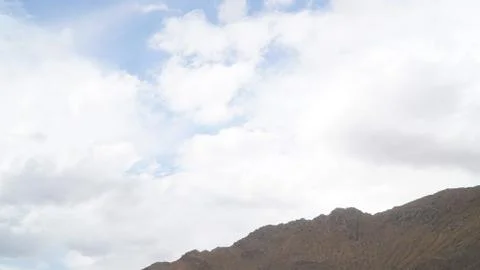 Mountain with some cloud on the blue clear sky Stock Photos