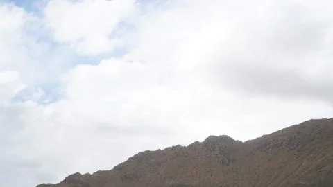 Mountain with some cloud on the blue clear sky Stock Photos