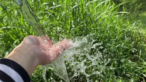 Mountain spring, clear water from the mountains flowing in the hand Stock Footage 276355890