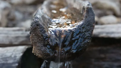 Mountain spring, equipped according to old technology using gutter made of wood. Stock Footage 121485284