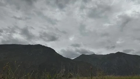 Mountain Storm Timelapse of Fast-Moving Dark Clouds, White Sky, and a Dark Stock Footage 286415789