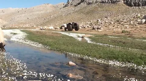 Mountain stream and a tractor Stock Footage 10817589