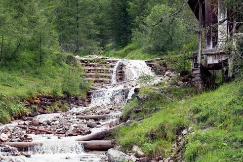Mountain stream bed fixed with logs in the Italian Dolomites Stock Photos