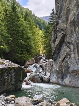 Mountain Stream Cascading Through Rocky Limestone Gorge 스톡 사진