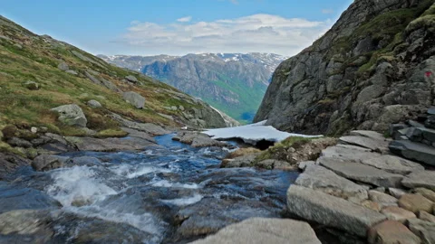 Mountain stream crossing hiking trail near Kjerag above Lysefjord in Norway. Stock Footage 328129783