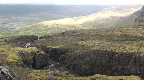 Mountain stream cutting through volcanic rock Stock Footage 37299134