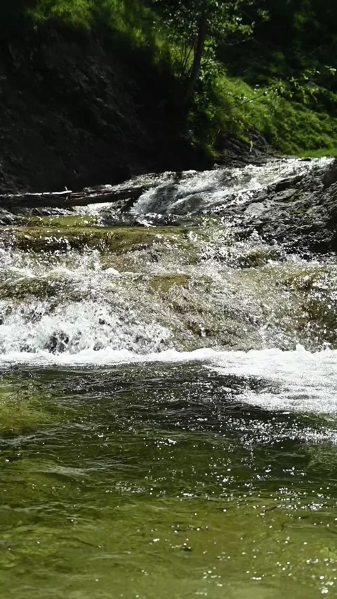 A mountain stream in direct sunlight, backlight, slow motion Stock-Footage 260890708