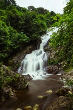 Mountain stream fall through the rock Stock Photos