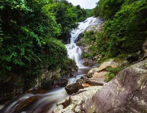 Mountain stream fall through the rock Stock Photos