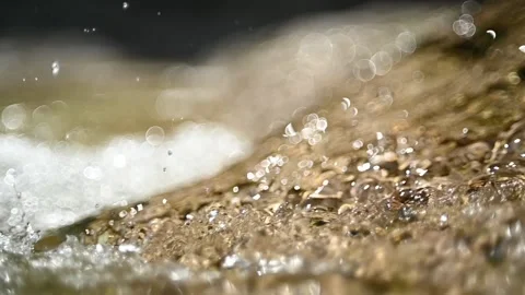 A mountain stream flow over rocks in sunlight (bokeh, slow motion) Stock-Footage 219641449