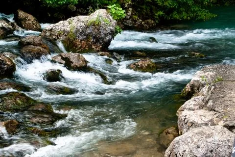 Mountain stream flowing over rocks Stock Photos