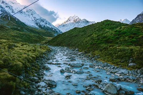 Mountain Stream Flowing Through Alpine Valley Stock Photos