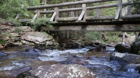 Mountain Stream Flowing Under Hiking Bridge 01 Stock Footage 41266111
