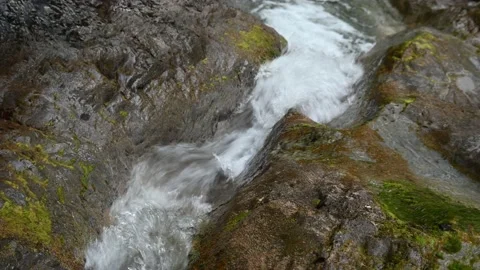 Mountain stream flows between rocks Stock Footage 211466312