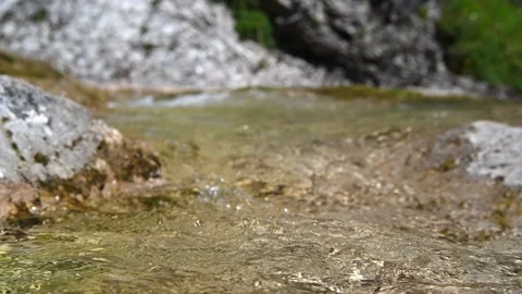 A mountain stream flows between rocks in summer Stock Footage 219636606