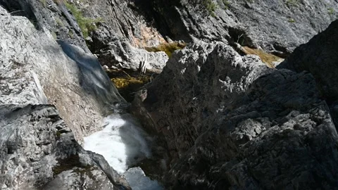 A mountain stream flows between rocks in summer Stock Footage 219645562