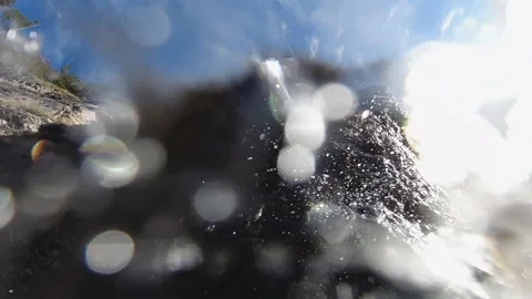 A mountain stream flows down from a large stone. Stock Footage 142122883