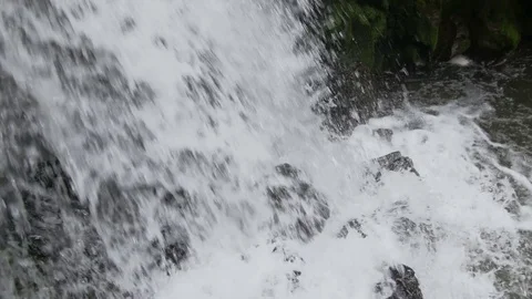 The mountain stream flows downward with cascades Stock Footage 78477784