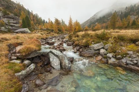 A mountain stream flows at fall Stock Photos