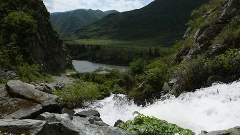 A mountain stream flows Stock Footage 76423812