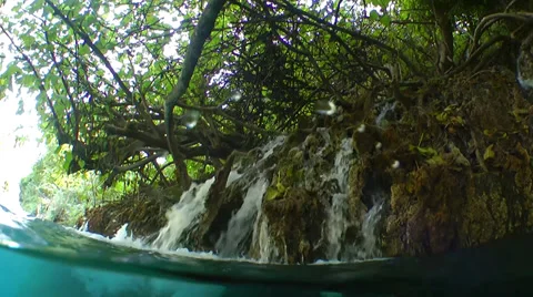 A mountain stream flows in a lake Stock Footage 37100485