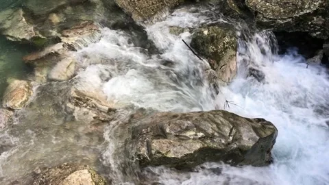 Mountain stream flows over the big stones Stock Footage 241791546