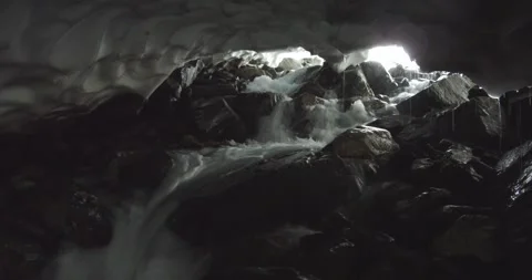 Mountain stream flows on the rocks under the snow. Ural Mountain. Stock Footage 269539849