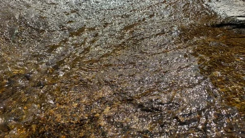 A mountain stream flows through large stones, foam from the flow of water Stock Footage 125310348