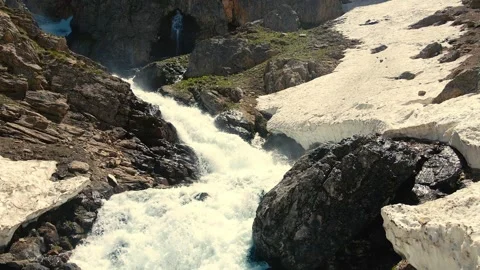 Mountain stream flows through rocky gorge 스톡 동영상 332490869