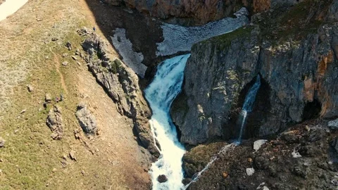 Mountain stream flows through rocky gorge 스톡 동영상 332490937