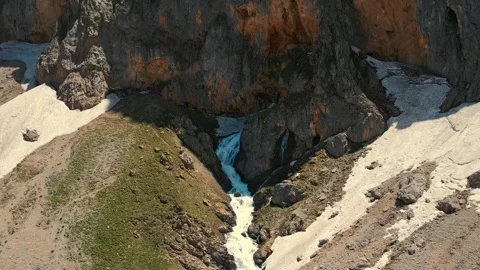 Mountain stream flows through rocky gorge 스톡 동영상 332491472