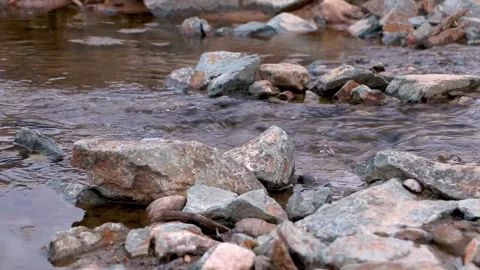 Mountain stream flows through the stony, rocky riverbed Video stock 151031021