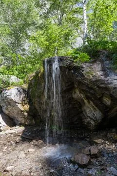 Mountain stream forming a waterfall in the forest, Altai, Russia Stock Photos