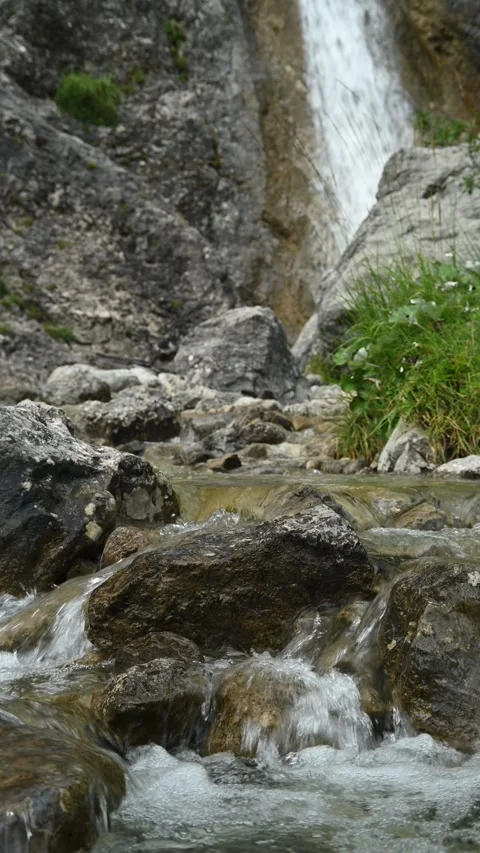 A mountain stream in front of a waterfall, vertical shot Stock-Footage 260889691