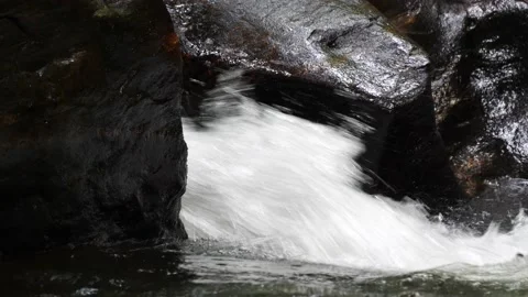 Mountain stream gushing through rocks Stock Footage 211444778