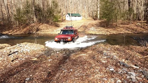 Mountain Stream River Crossing with SUV Video stock 260098410