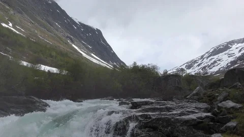 Mountain stream river snow rushing Stock Footage 77236439