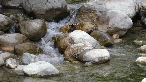 Mountain stream with rocks and waterfall Stock Footage 98235620