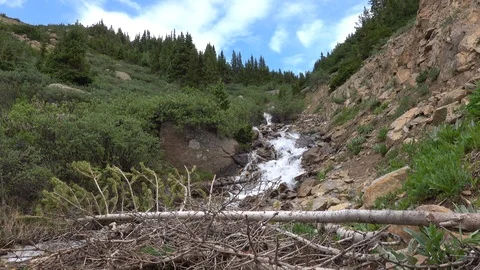 Mountain stream runs down steep rocky ravine. Stock Footage 117576319