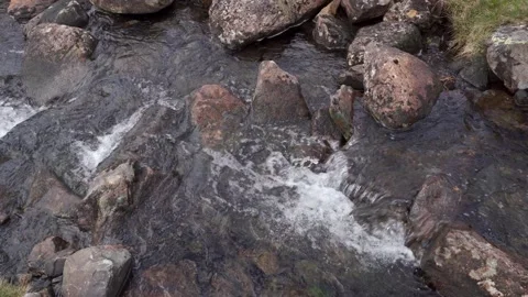 Mountain stream water rushing over rocks and boulders Stock Footage 274054094