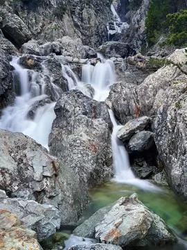 Mountain stream winding through a rocky canyon, creating a stunning sequence of Stock Photos