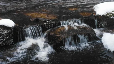 Mountain stream in the winter. Snow covered stones. Stock Footage 232344289