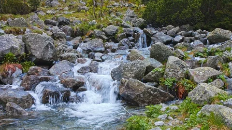 Mountain streams flow down steep cliffs. Stock Footage 119114154