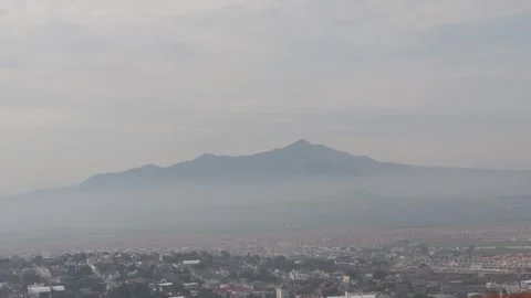 Mountain strutting out through the mist Stock Footage 314282028