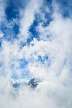 Mountain summit covered by sea of cloud with blue sky in the morning 写真素材