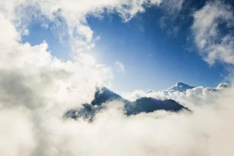 Mountain summit covered by sea of cloud with blue sky in the morning 写真素材