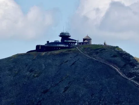 Mountain summit observatory beside a small chapel under cloudy sky Stock Photos