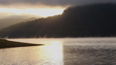 Mountain Sunrise landscape in the wilderness with fog covering the lake Stock Footage