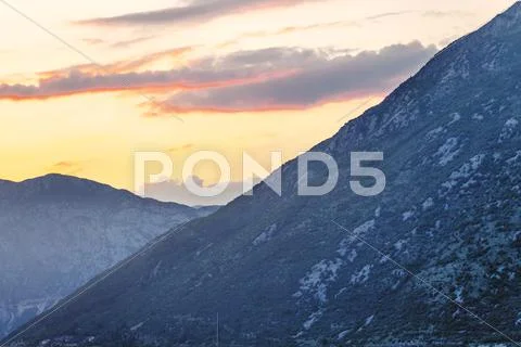 Mountain sunset and colored sky with clouds Stock Photos