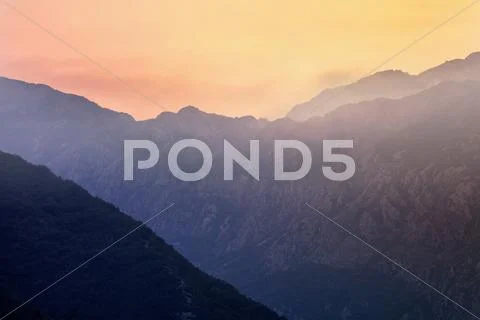 Mountain sunset and colored sky with clouds Stock Photos
